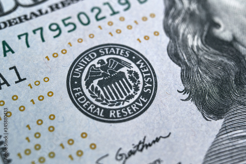 macro photo of federal reserve system symbol on hundred dollar bill. shallow focus. close-up with fine and sharp texture photo