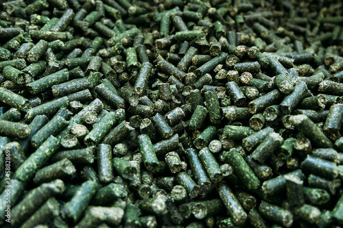 a large number of alfalfa green granules in a warehouse for the production of agricultural feed