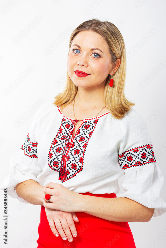 Fashion portrait of a young woman in a charming blouse. Girl in an embroidered shirt. Handmade things. Fashion portrait of a young woman in a charming blouse. Girl in an embroidered shirt. Handmade things.