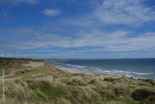 Panoramic view of windswept beach on a sunny day in County Down  Northern Ireland. 