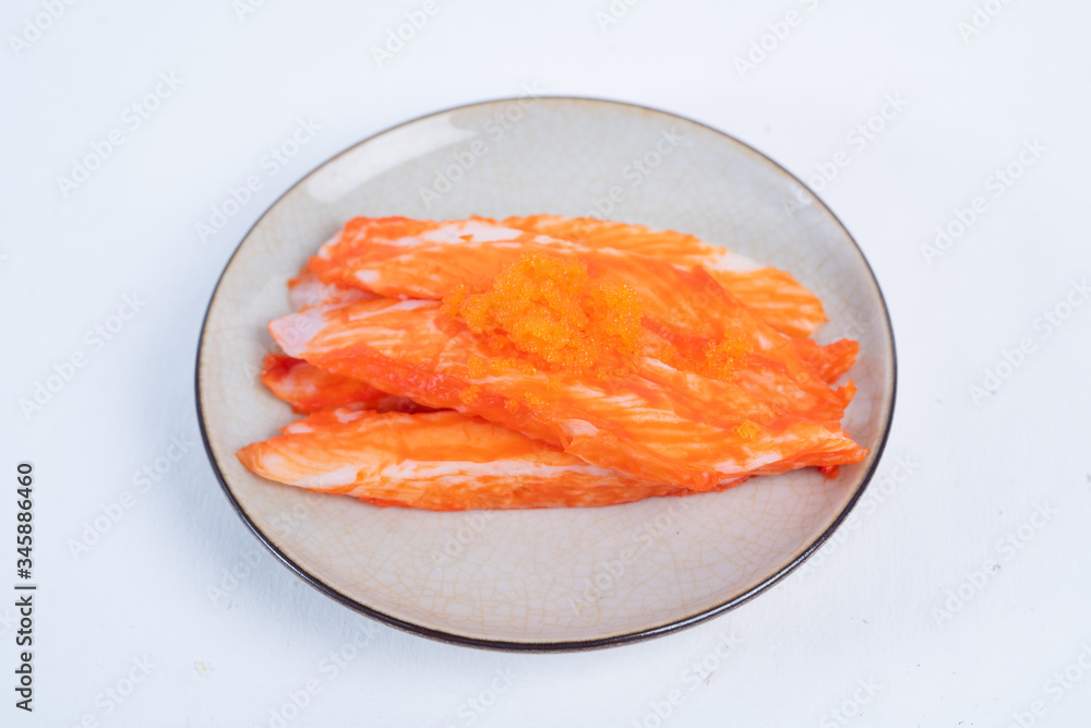 Crab sticks on the plate that is on the table Crab sticks on the plate that is on the table