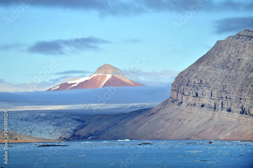 Beauty of nature. Landscape of polar latitudes. Snowy mountains. Reflection in sea water.