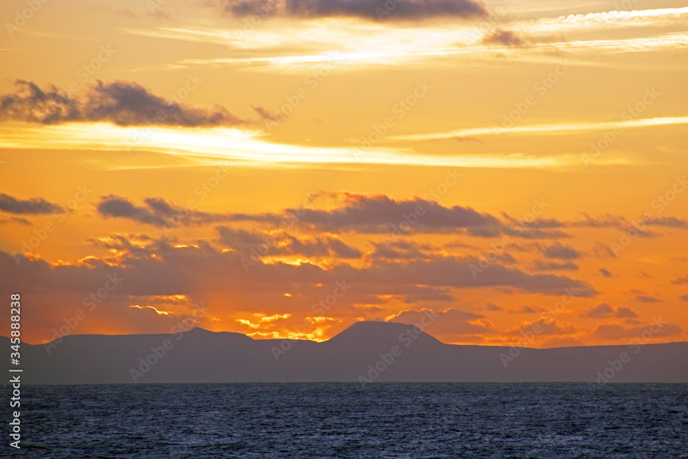 Bright sunset on the Atlantic Ocean. View from the open ocean to the Canary Islands.