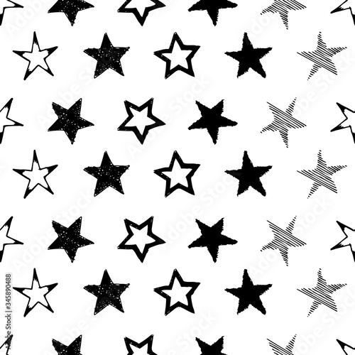 Seamless background of doodle stars. Black hand drawn stars on white background. Vector illustration 