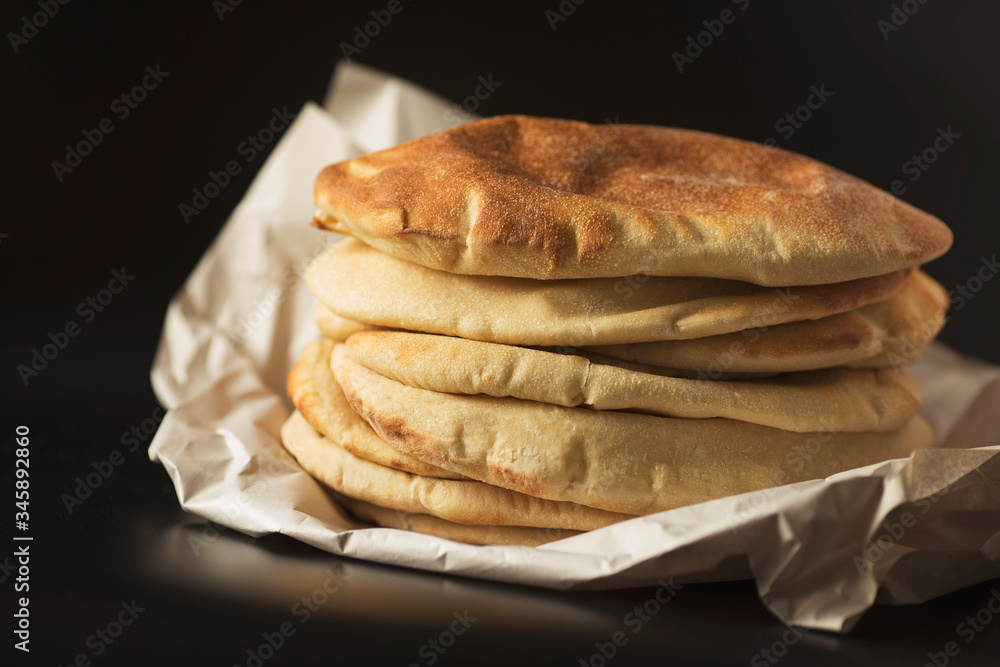 stack of pita bread lavash, healthy homemade traditional eastern flatbread bread lavash, cyprus, turkish bread, on the black background stack of pita bread lavash, healthy homemade traditional eastern flatbread bread lavash, cyprus, turkish bread, on the black background