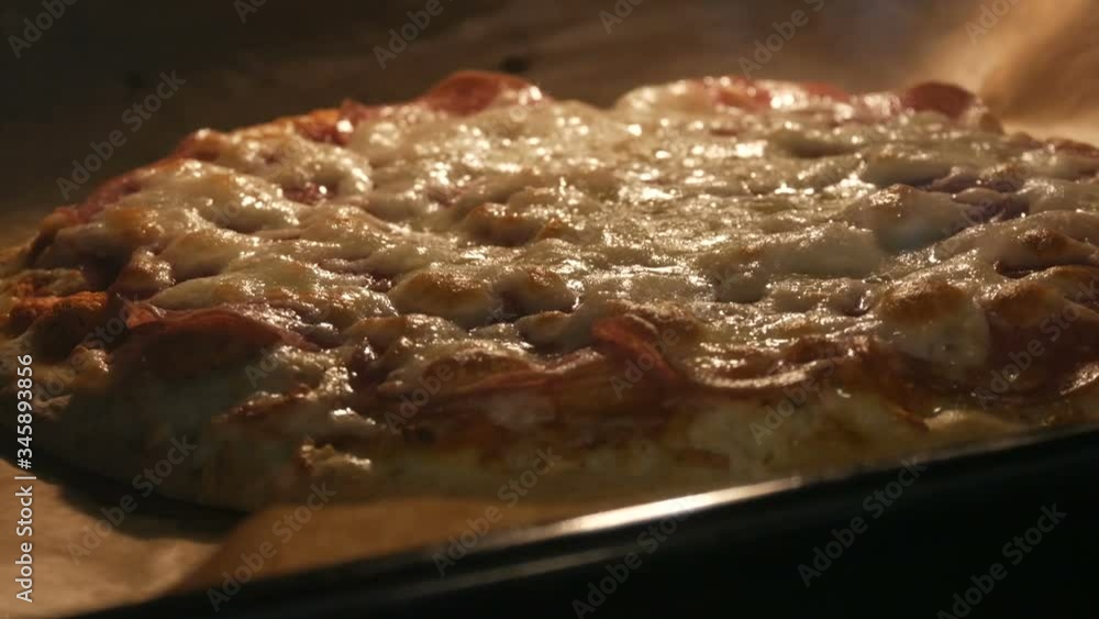 Italian pizza is baked in the oven at home. Cheese melts on pizza surface Italian pizza is baked in the oven at home. Cheese melts on pizza surface