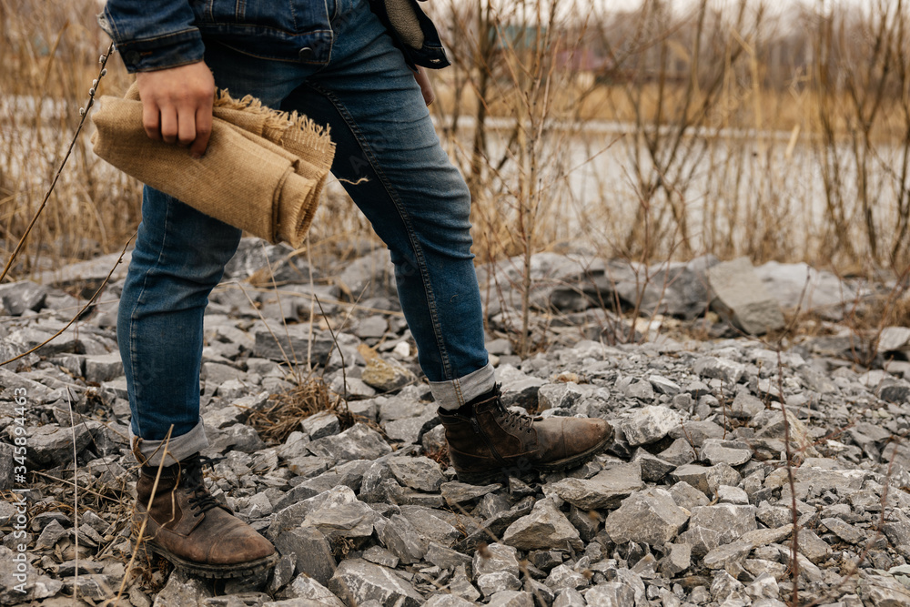 legs of a man in boots on stones legs of a man in boots on stones
