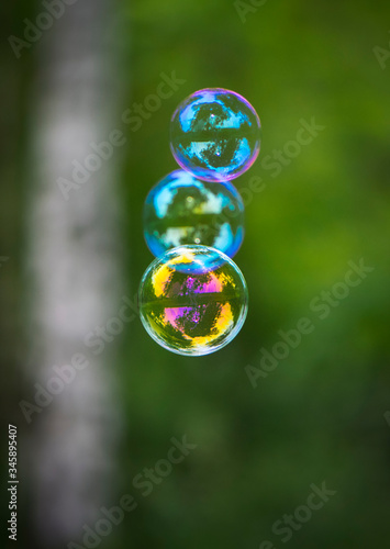 three soap bubbles on a green background