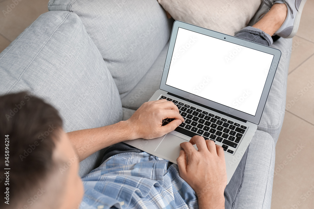Naklejka premium Handsome man with laptop at home