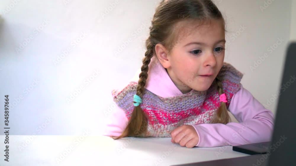 Distance learning. Online school and little girl watching. Home isolation and online lessons. Quarantine and schooling. Distance learning. Online school and little girl watching. Home isolation and online lessons. Quarantine and schooling.
