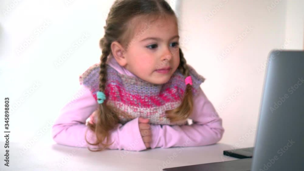Distance learning. Online school and little girl watching. Home isolation and online lessons. Quarantine and schooling. Distance learning. Online school and little girl watching. Home isolation and online lessons. Quarantine and schooling.