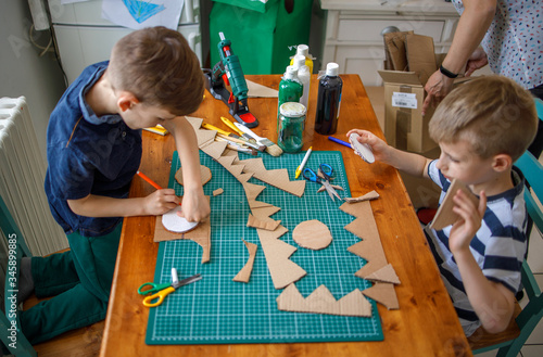 Fotografija Boys making  cardboard costume
