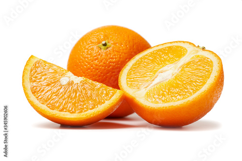 Fresh orange fruits whole and sliced macro photo isolated on white background