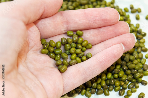 Green bean mung in a woman's hand.