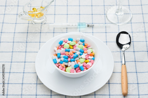a plate of pills and medications on the table © Atrom