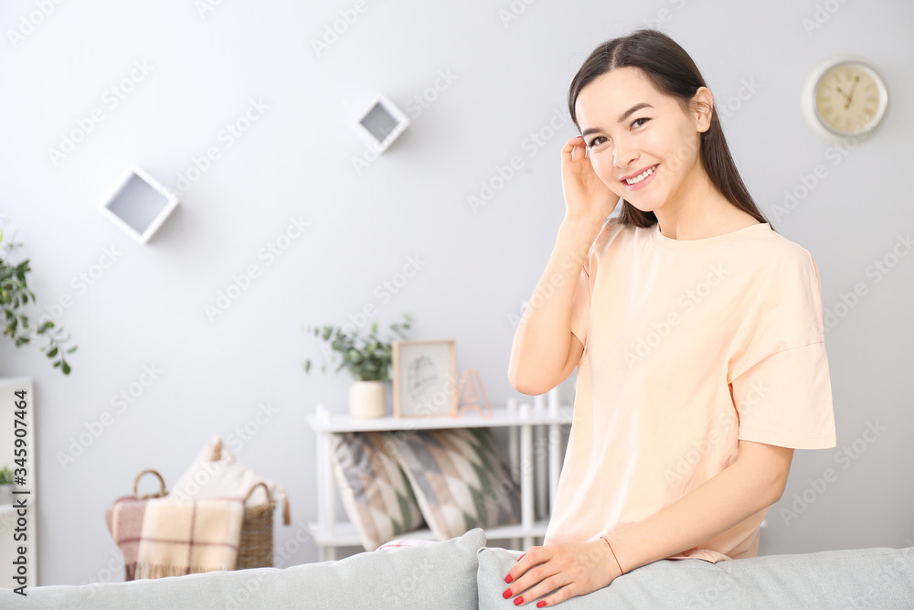 Portrait of beautiful young woman resting at home