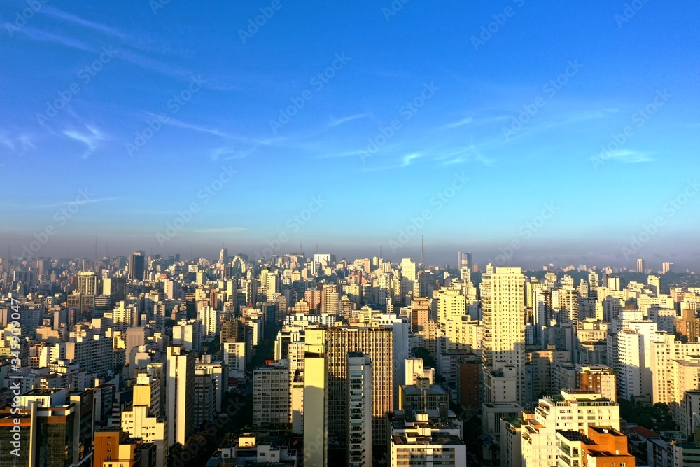 Panoramic view sunrise in the city life scene with blue sky above skycrapers. Great landscape.