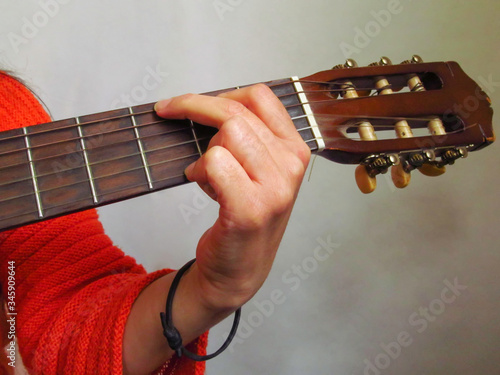 Simple guitar chords, woman playing acoustic guitar, close up photography