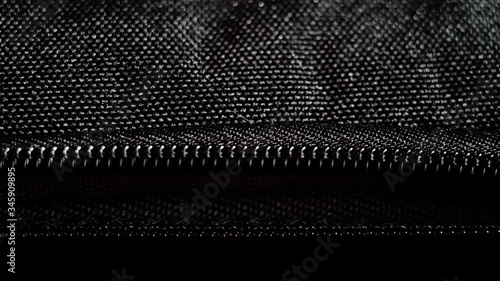 Wallpaper Mural Buttoning a black zippers closeup. Black fabric material texture macro zipper.  Torontodigital.ca