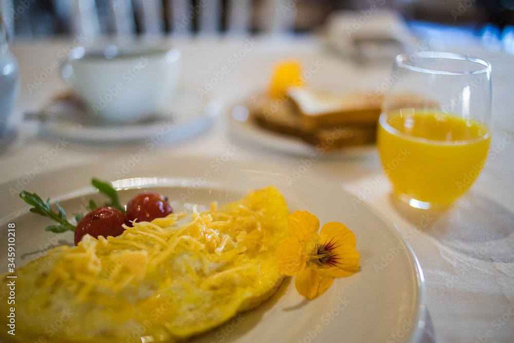 Close up image of a delicious omelet being served as breakfast in a gourmet restaurant Close up image of a delicious omelet being served as breakfast in a gourmet restaurant