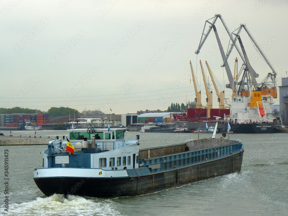 Fototapeta premium Frachtschiffe und Container im Hafen von Antwerpen.