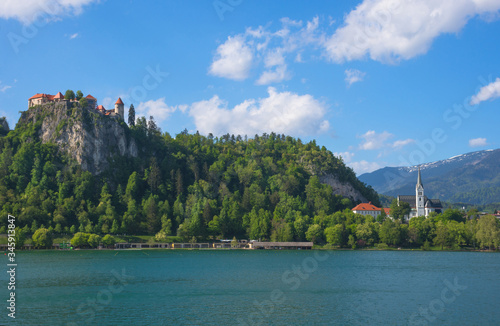 Sunny spring morning at Lake Bled and old medieval castle on the rock, famous tourist attraction in Slovenia
