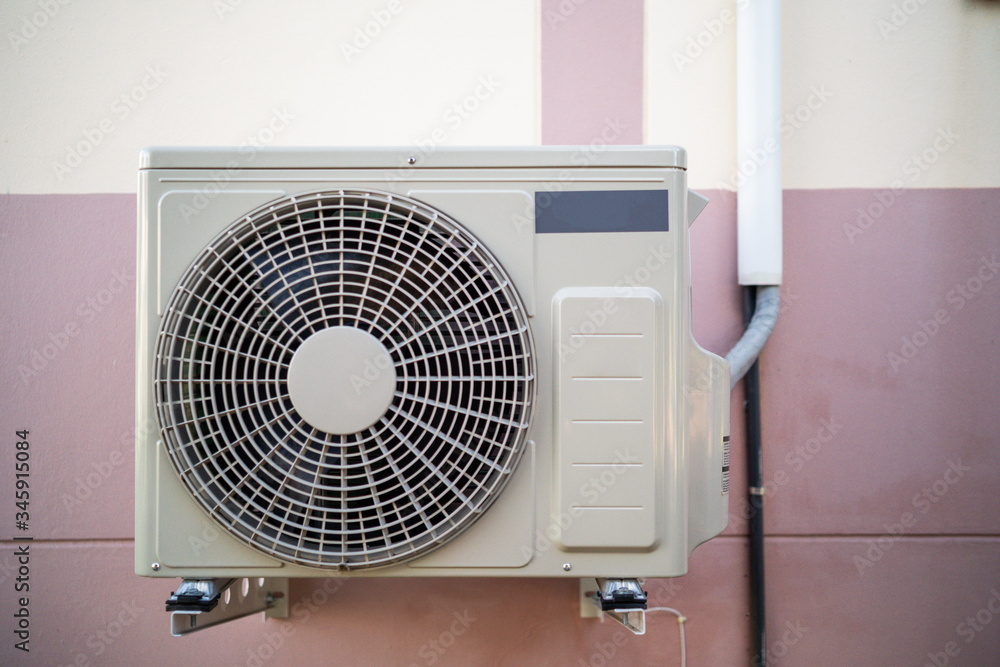 Air conditioner compressor on home wall. Air conditioner compressor on home wall.