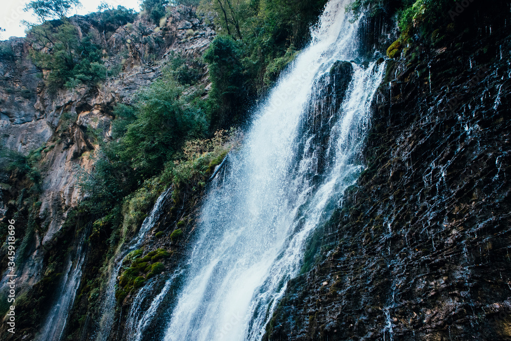 Beautiful high waterfall Kapuzbasi in Turkey, stone mountain blue stream water