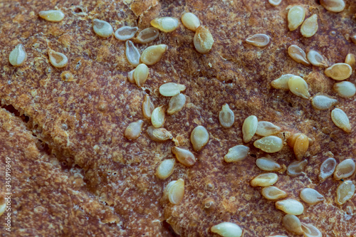 Golden brown bread crust close up with sesame seeds