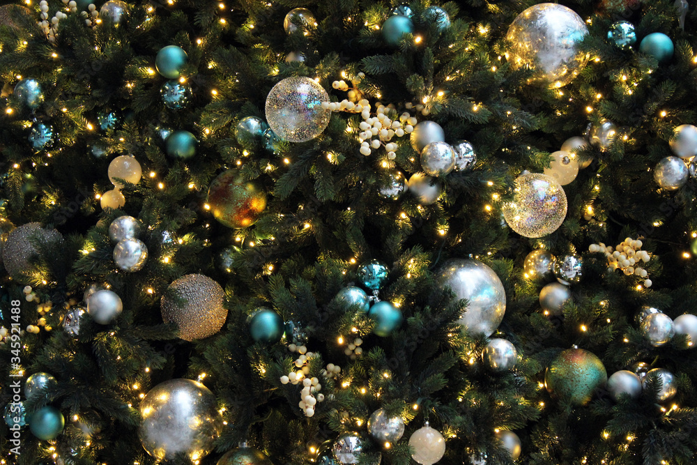 Christmas decorations on Christmas tree with fairy lights and clear and glitter baubles Christmas decorations on Christmas tree with fairy lights and clear and glitter baubles