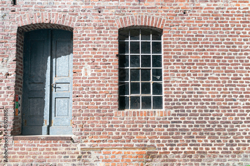 Brick facade with old door and tiled window