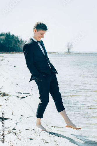 Senior man groom walking on the beach seaside barefoot