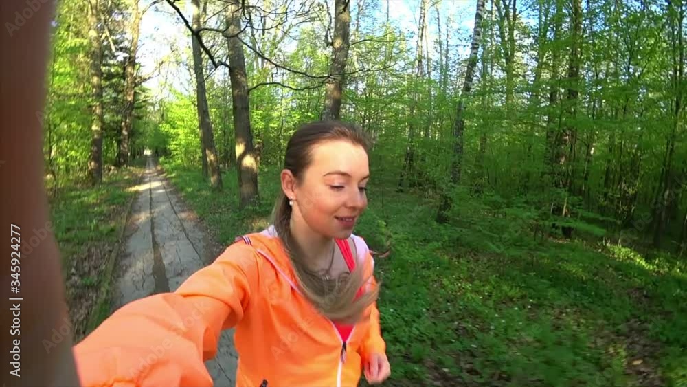 Sport girl jogging in slow motion outside and filming herself with action camera pov Sport girl jogging in slow motion outside and filming herself with action camera pov
