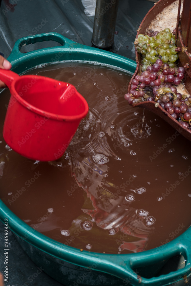 Freshly squeezed grape juice during food and wine festival.
