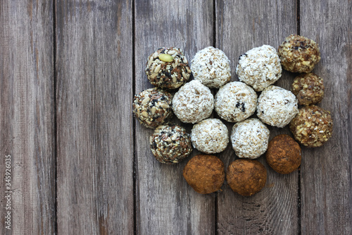  Energy balls in the form of a heart on a dark wooden background, flat lay, mine space