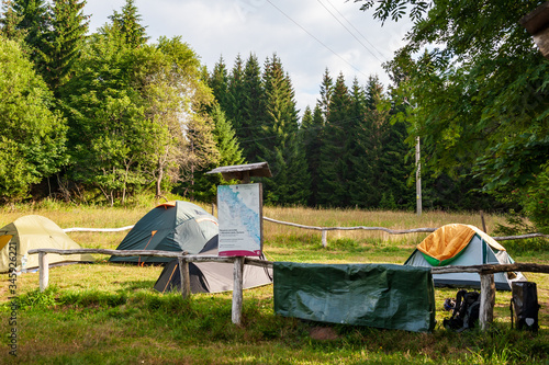 Emergency overnight campsite Bučina Sumava, Bohemian Forest, Böhmerwald, Czech Republic. Several tents camping on grass in forest campsite.