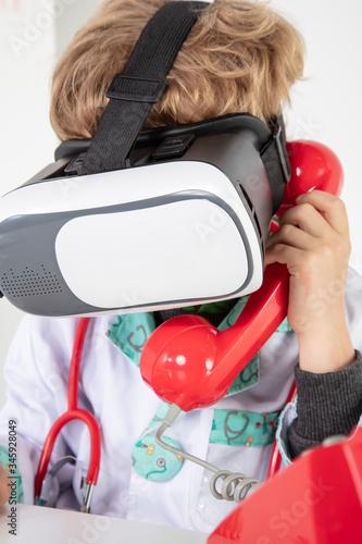 young doctor in virtual reality goggles talking on the phone, a symbol of globalization