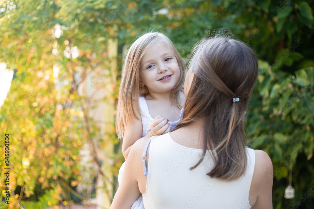 mother and daughter in garden in summer mother and daughter in garden in summer