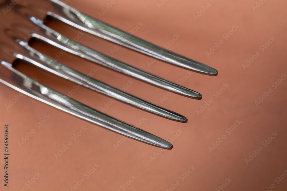 tines of a fork on a plain background tines of a fork on a plain background