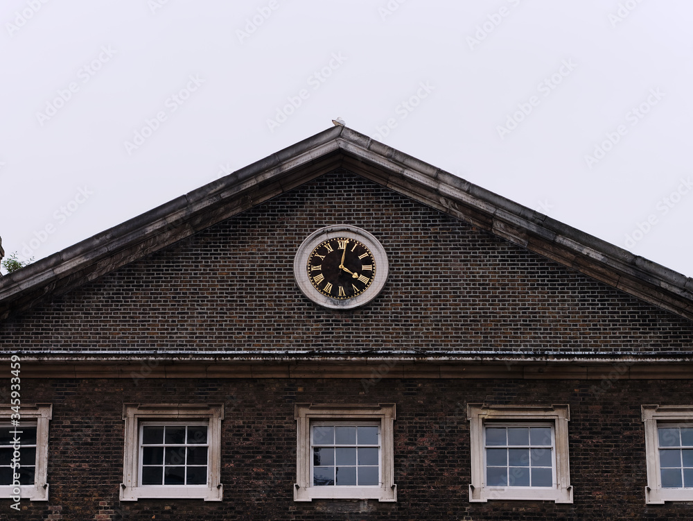 Roof of old house with clock