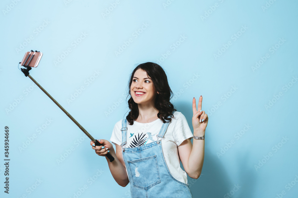 Portrait of a happy young asian girl making selfie isolated over blue background Portrait of a happy young asian girl making selfie isolated over blue background
