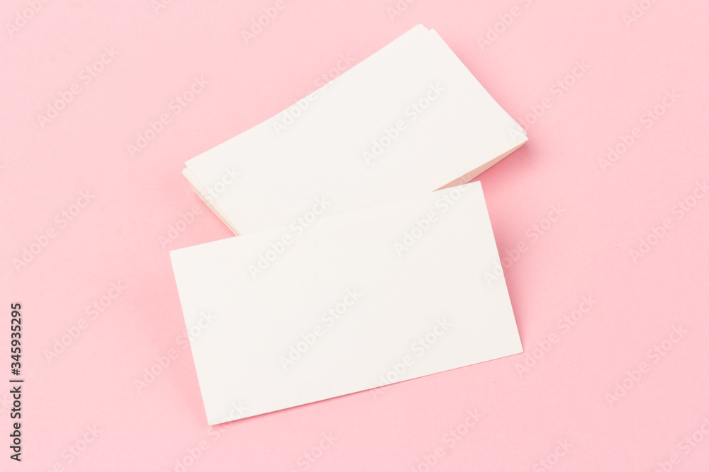 white blank business cards on pink background in close-up white blank business cards on pink background in close-up
