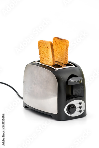 Toasts jumping out of retro style black and metallic toaster on white background. Levitation 

food. Kitchen equipment for fresh morning meal
