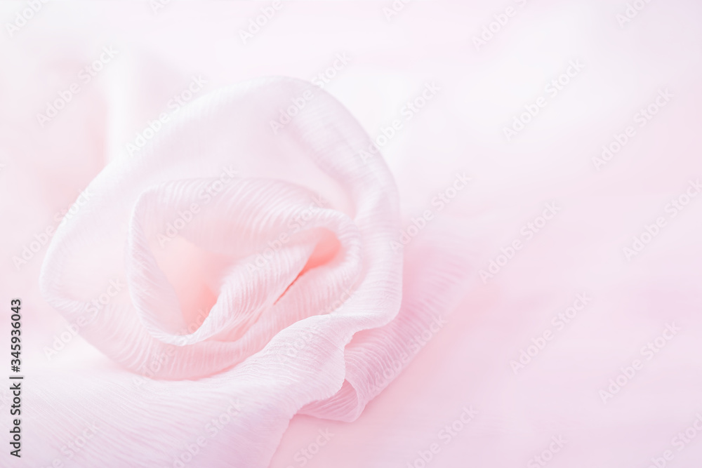 Silk pink flower rose on a pale pink background, copy space Silk pink flower rose on a pale pink background, copy space