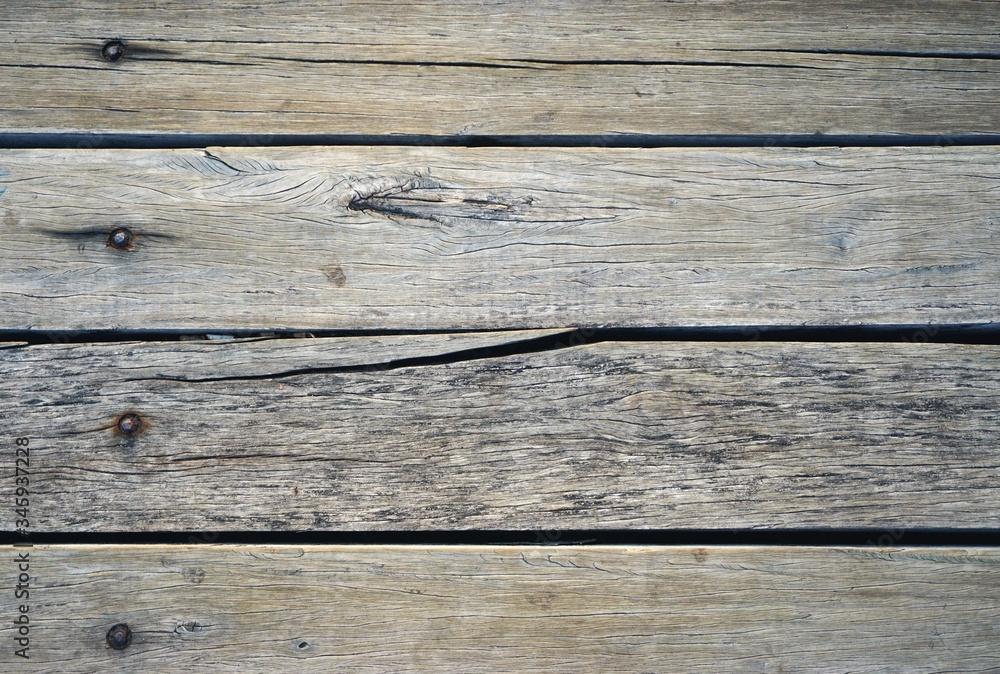 Weathered wooden planks with cracked horizontal board Weathered wooden planks with cracked horizontal board