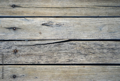 Weathered wooden planks with cracked horizontal board