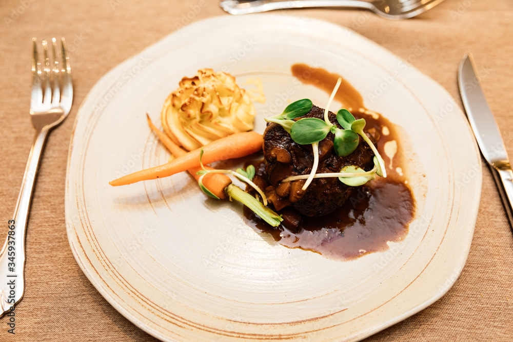 Grilled Angus beef tenderloin with honey glazed baby carrots, duchess potatoes and mushroom jus