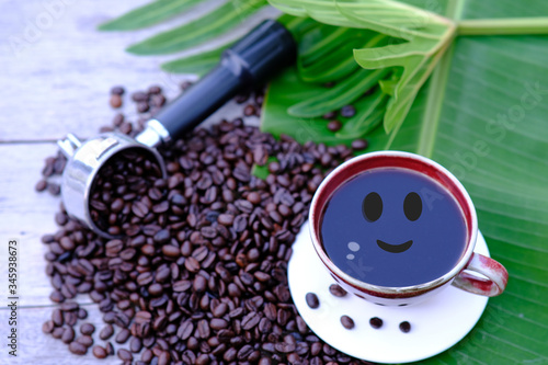 Coffee cup and coffee beans on wooden table background