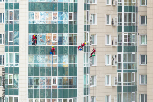 Industrial climbers washing windows of a building
