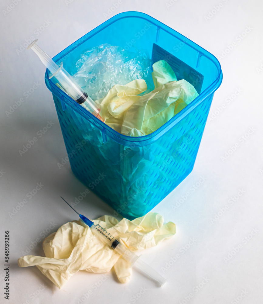 Used syringes, surgical gloves and plastic bags in gurbage bin Used syringes, surgical gloves and plastic bags in gurbage bin